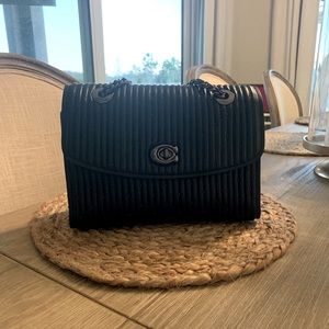 A beautiful black coach bag